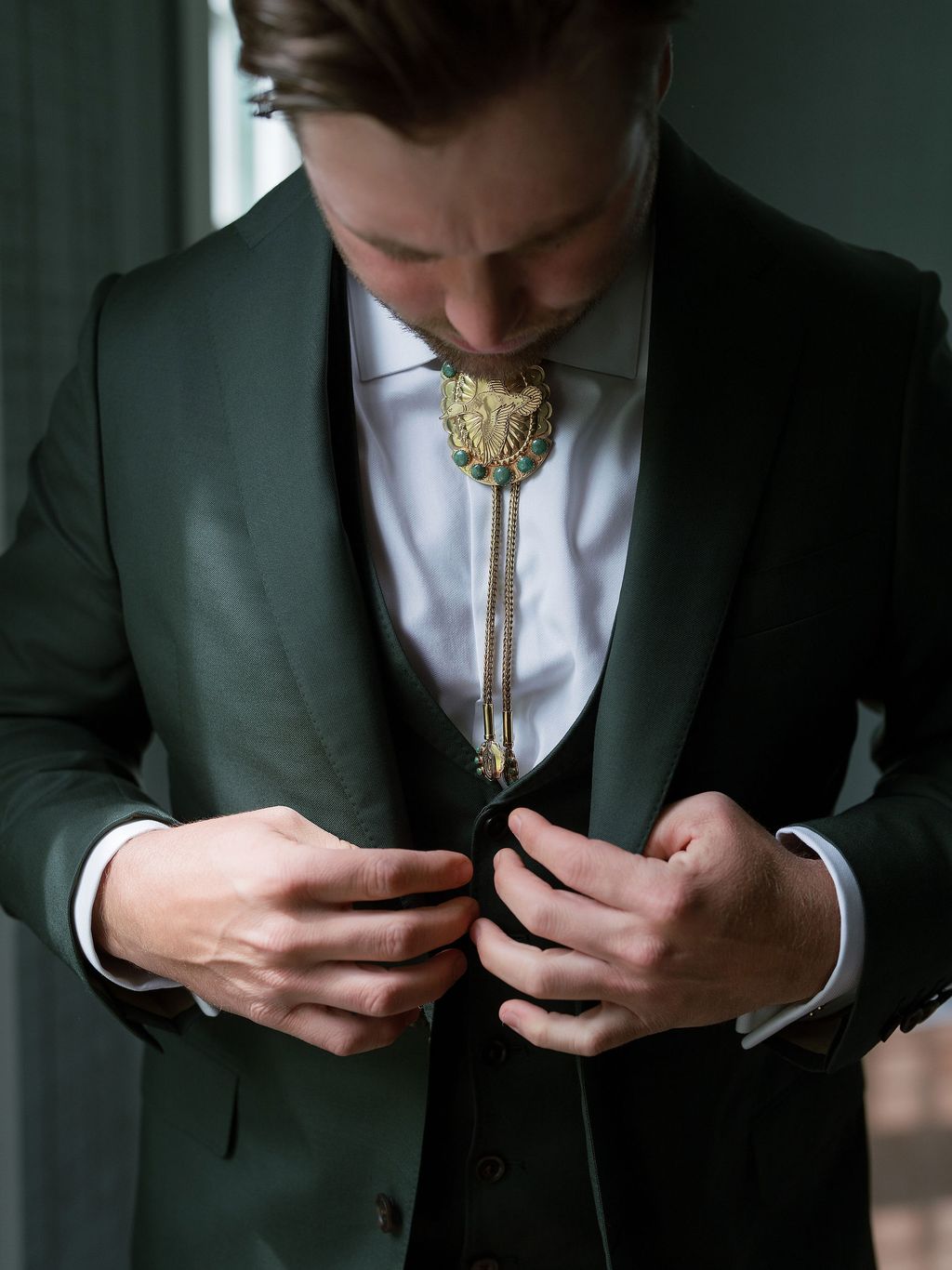 Image may contain Clothing Formal Wear Suit Coat Jacket Blazer Tuxedo Adult Person Accessories and Jewelry