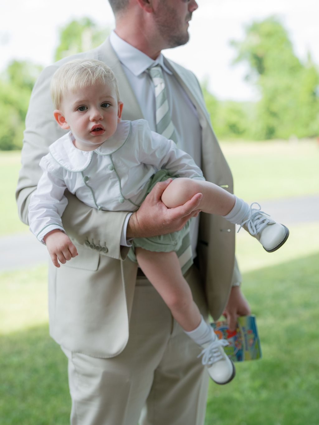 Image may contain Blazer Clothing Coat Jacket Formal Wear Suit Footwear Shoe Accessories Tie Face and Head