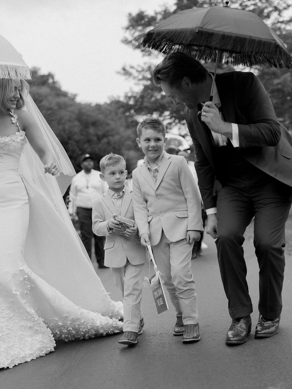 Image may contain Clothing Dress Fashion Formal Wear Gown Suit Coat Wedding Wedding Gown Adult Person and Child