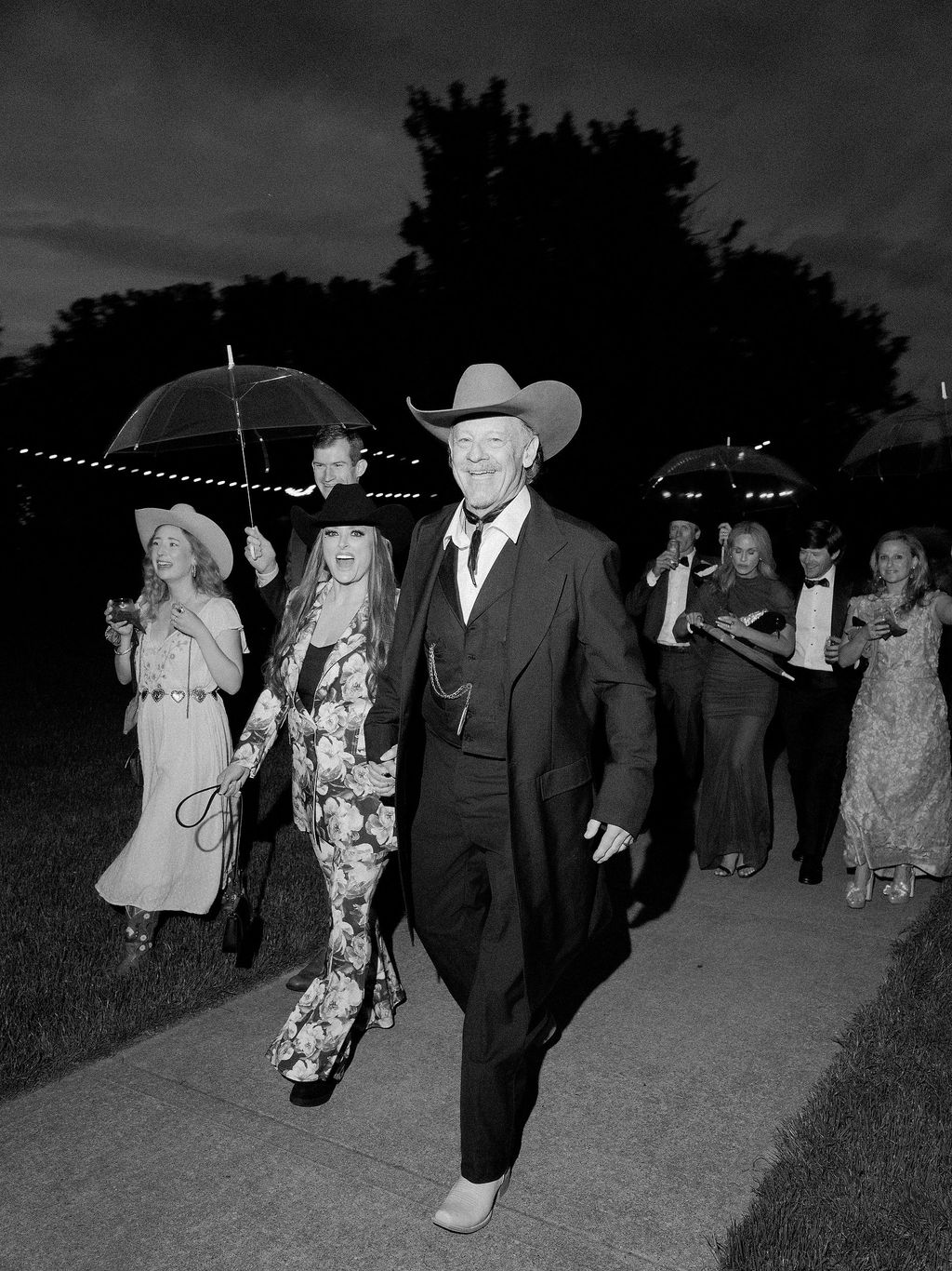 Image may contain Wynonna Judd Lisa Emery Clothing Formal Wear Suit Coat Hat Person Adult Wedding and Walking