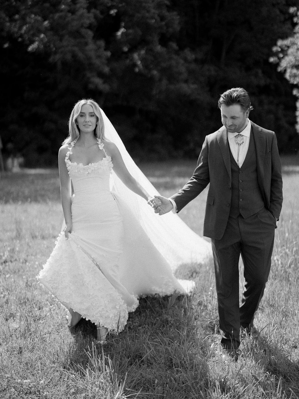 Image may contain Clothing Dress Formal Wear Suit Fashion Gown Face Head Person Photography Portrait and Wedding