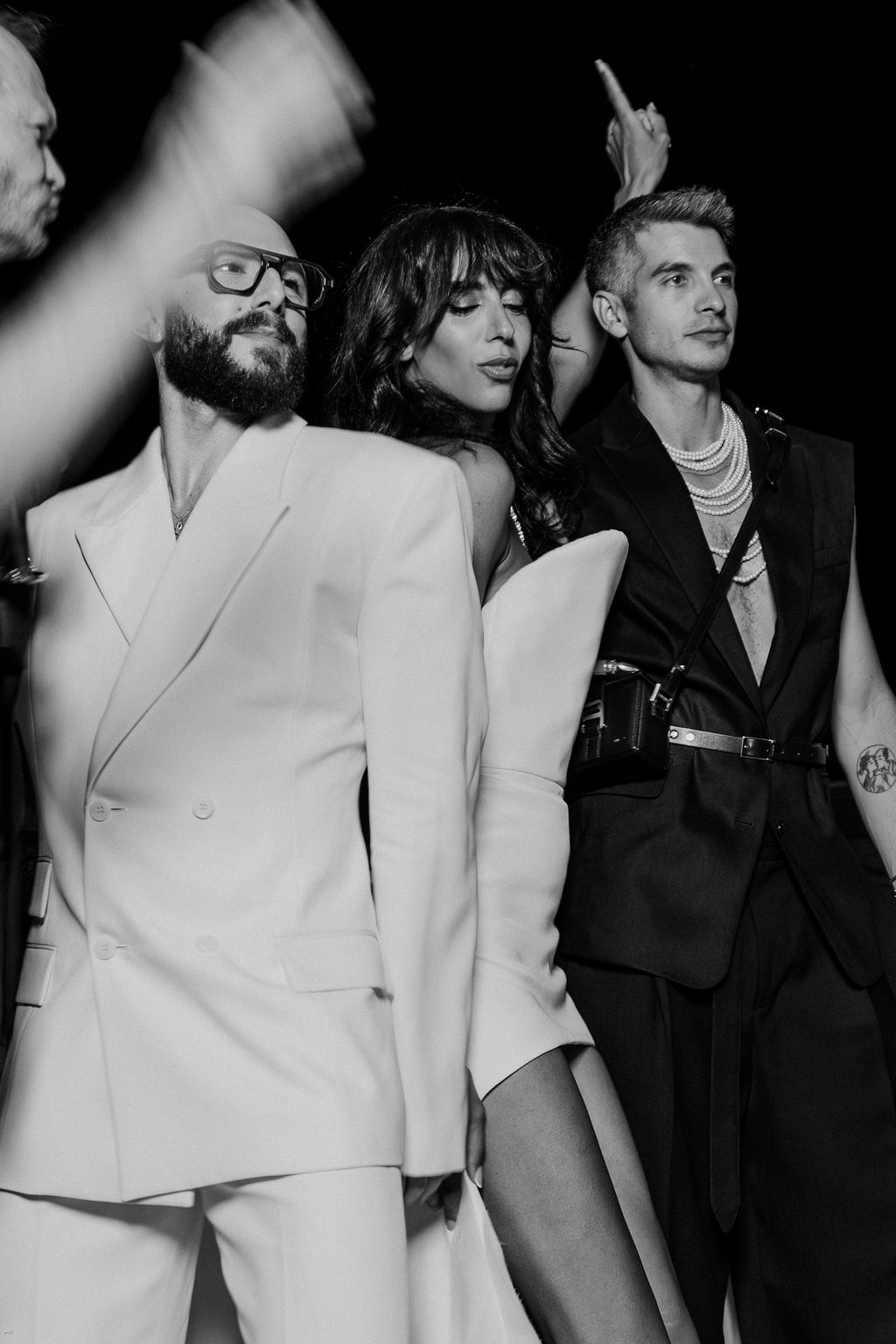 Image may contain Clothing Coat Body Part Finger Hand Person Formal Wear Suit Adult Photobombing Face and Head
