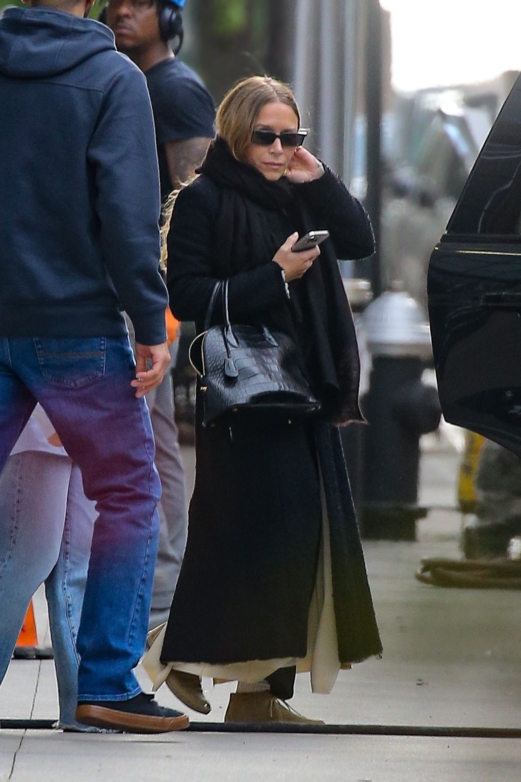Image may contain MaryKate Olsen Adult Person Clothing Pants Accessories Bag Handbag Pedestrian Glasses and Jeans