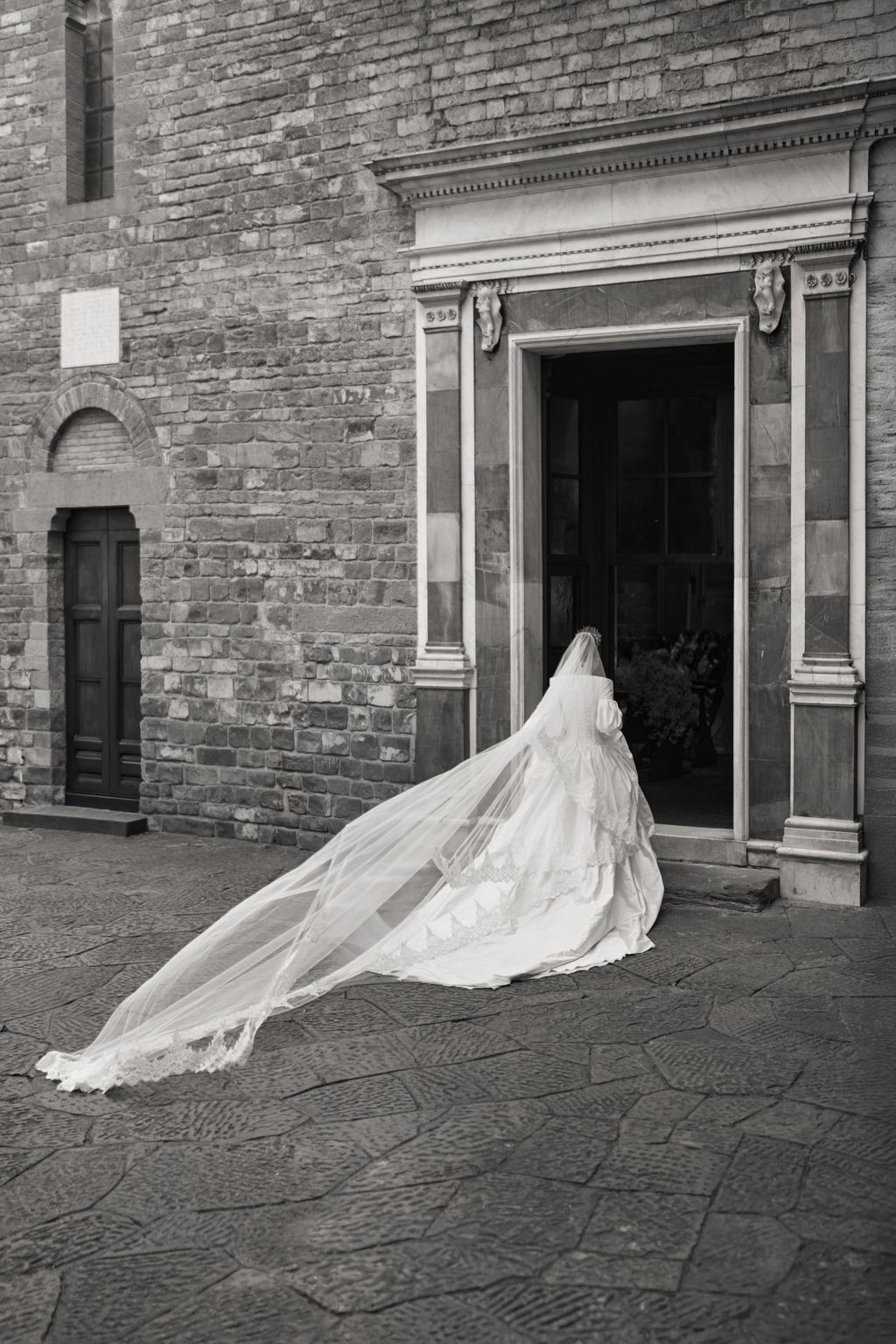 Image may contain Clothing Dress Brick Fashion Formal Wear Gown Wedding Wedding Gown Bridal Veil Person and Face