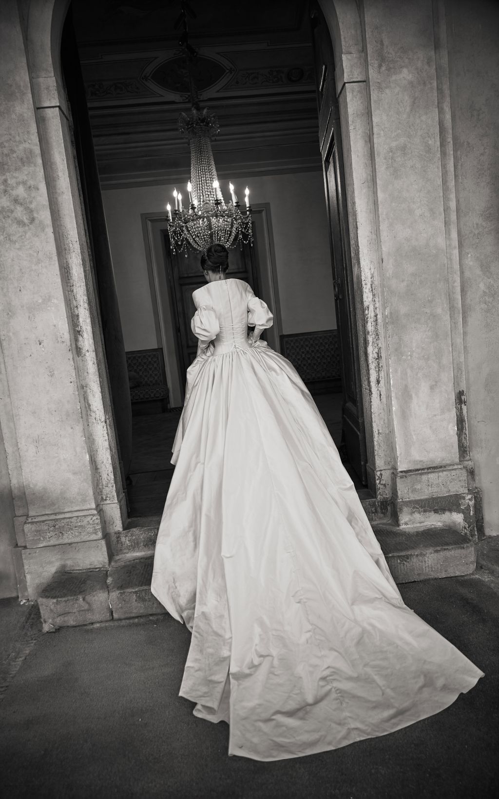 Image may contain Chandelier Lamp Clothing Dress Formal Wear Fashion Gown Wedding Wedding Gown Adult and Person