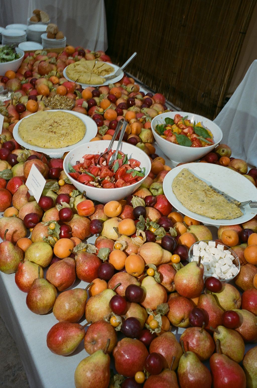 Image may contain Brunch Food Meal Cafeteria Indoors Restaurant Buffet Fruit Pear Plant Produce Adult and Person