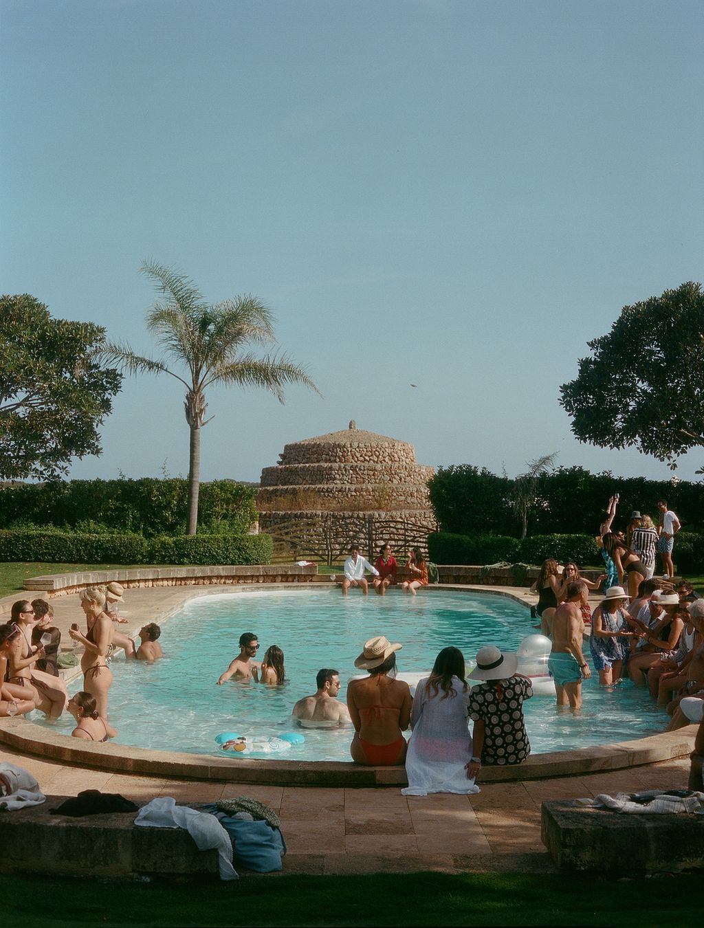 Image may contain Summer Pool Water Plant Tree Swimming Pool Grass Potted Plant Person Adult Wedding and Clothing