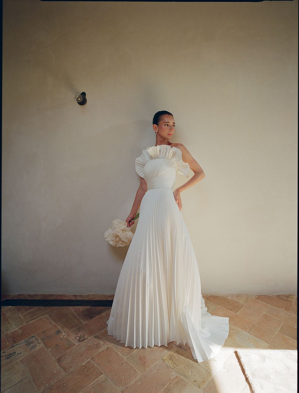 Image may contain Clothing Dress Fashion Formal Wear Gown Wedding Wedding Gown Adult Person Evening Dress and Face