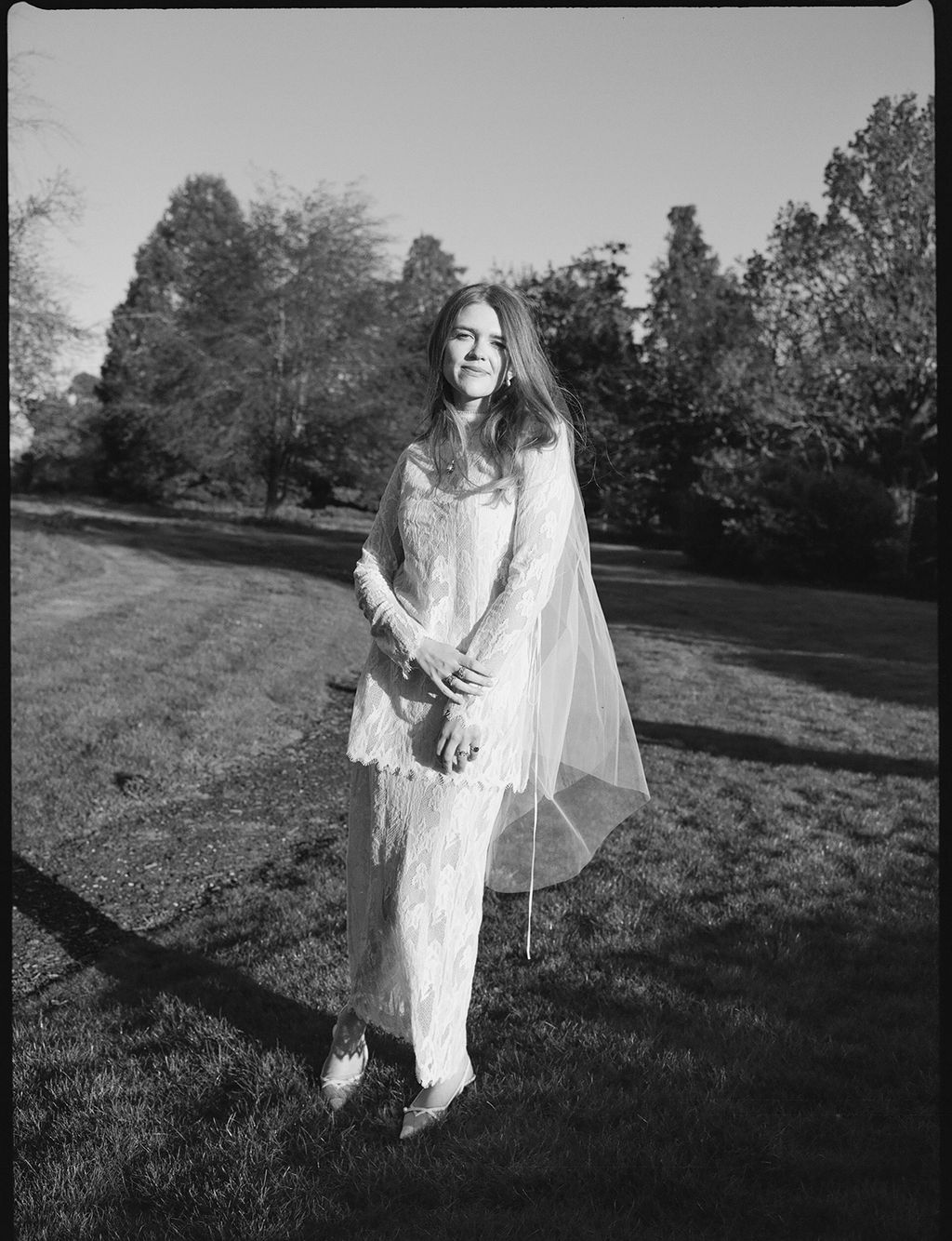 Image may contain Face Head Person Photography Portrait Grass Plant Clothing Dress Formal Wear Fashion and Gown