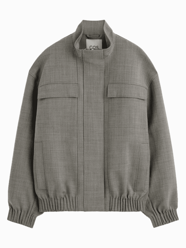 Image may contain Clothing Coat Jacket Knitwear Sweater Home Decor and Linen